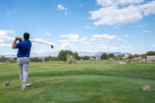 Golfer driving a golfball on a course in Eurpoe
